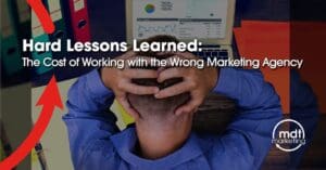 Image of a person working on his laptop and scratching the back of his head with his two hands with a text on the image showing Hard Lessons Learned: The Cost of Working with the Wrong Marketing Agency