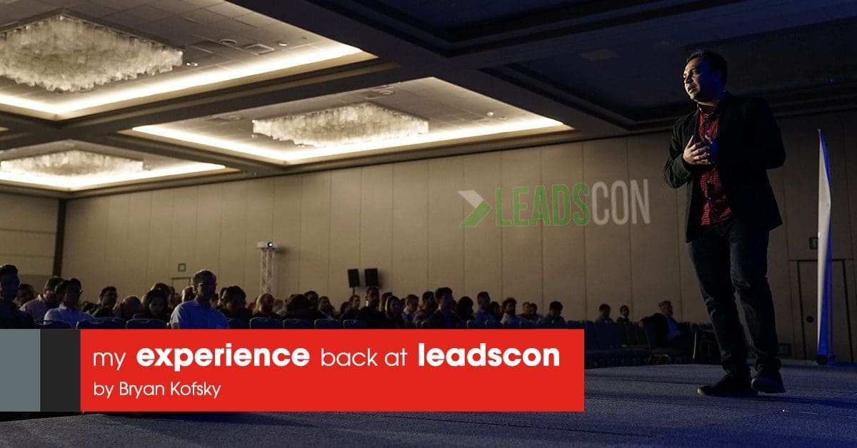 Image of a person standing on stage with many audiences and a text over the image showing my experience back at leadscon by Bryan Kofsky